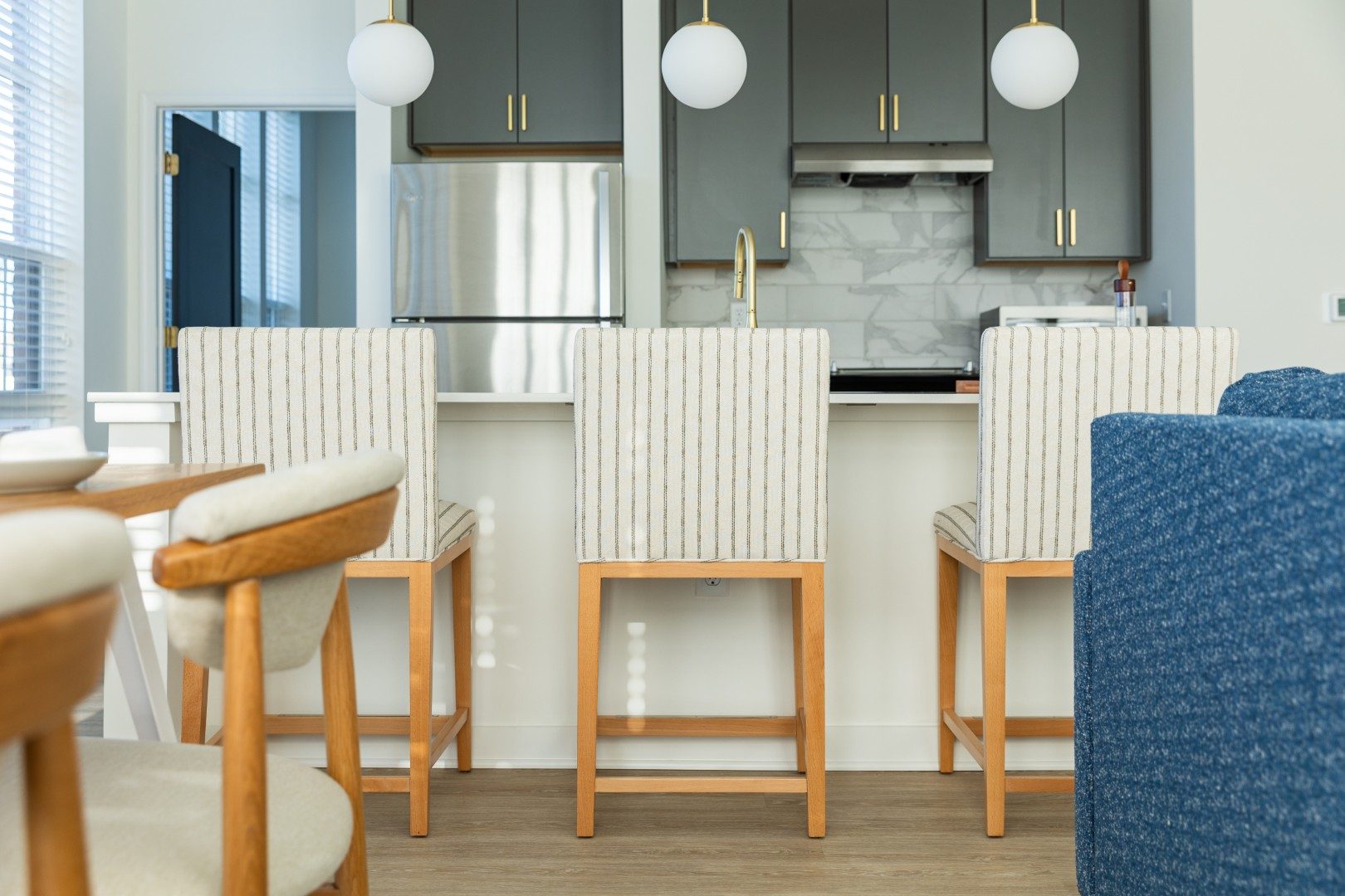 Striped counter stools at a kitchen island