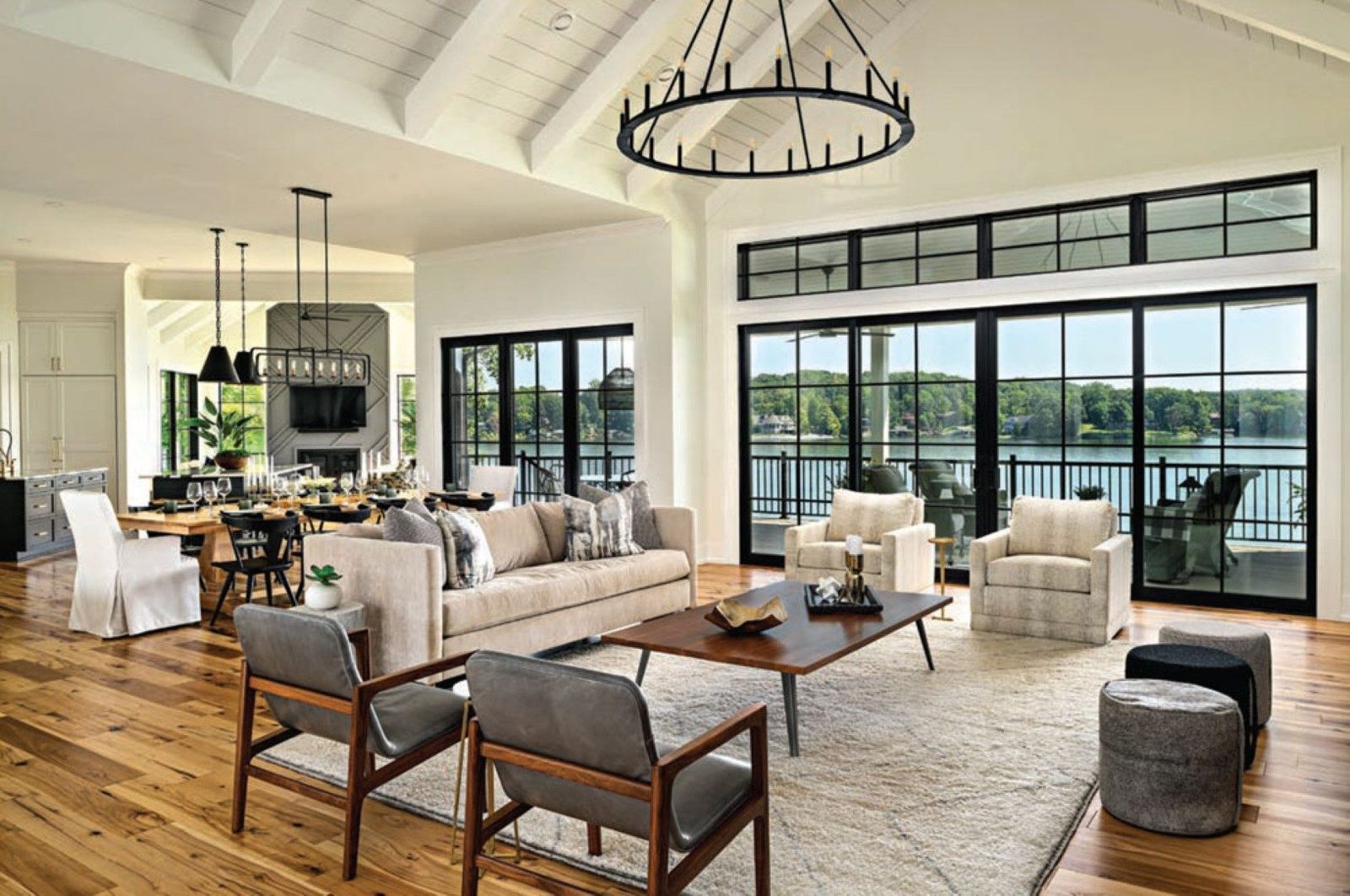 Open lakeside great room with a sectional, lounge chairs and wood coffee table